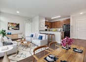 Thumbnail 1 of 18 - A modern living room with a dining table set for two.