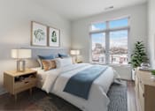 Thumbnail 4 of 18 - A bedroom with a large bed and a window overlooking a cityscape.