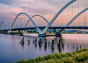 Thumbnail 4 of 4 - A bridge with a unique design spans across a body of water.