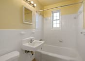 Thumbnail 18 of 18 - A white sink with a mirror above it in a bathroom.
