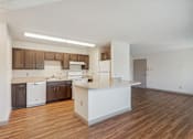 Thumbnail 1 of 20 - A kitchen with brown cabinets and a white counter.
