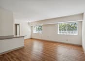 Thumbnail 4 of 20 - A room with wooden floors and a window.