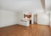 Thumbnail 5 of 20 - A large empty room with wooden floors and white walls.