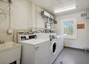 Thumbnail 14 of 20 - A laundry room with a washer and dryer.