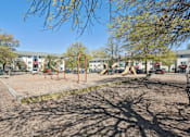 Thumbnail 17 of 20 - A playground with swings and a slide.