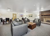Thumbnail 6 of 12 - a living room with couches and chairs and a fireplace