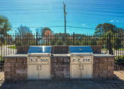 Thumbnail 5 of 52 - two gas bbqs in front of a stone wall with a fence  at Bayville Apartments, Virginia, 23455