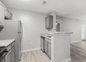 Thumbnail 4 of 35 - the spacious kitchen with stainless steel appliances and white countertops at Midtown Crossing in Raleigh, North Carolina