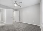 Thumbnail 8 of 35 - an empty room with white walls and a ceiling fan at Midtown Crossing in Raleigh, NC 27609