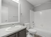 Thumbnail 13 of 35 - a bathroom with a sink toilet and a bath tub at Midtown Crossing in North Carolina 27609