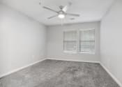 Thumbnail 10 of 35 - an empty room with a ceiling fan and a window at Midtown Crossing in Raleigh, North Carolina 27609