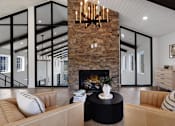 Thumbnail 2 of 51 - A living room with a fireplace and a couch.