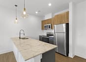 Thumbnail 1 of 44 - A kitchen with a granite countertop and stainless steel appliances.