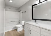 Thumbnail 44 of 67 - A white bathroom with a toilet, sink, and bathtub.