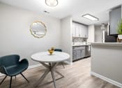 Thumbnail 2 of 50 - A modern kitchen with a round table and a single chair.