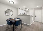 Thumbnail 10 of 67 - A dining room with a table and chairs.