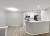 Thumbnail 28 of 67 - A kitchen with white cabinets and a white countertop.