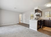 Thumbnail 10 of 33 - an empty kitchen and living room with a kitchen counter top and