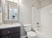 Thumbnail 13 of 33 - a bathroom with a toilet sink and tub and a mirror