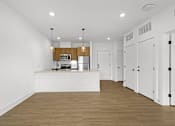Thumbnail 12 of 44 - A kitchen with white cabinets and a wooden island.
