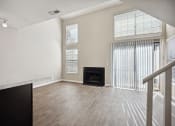 Thumbnail 11 of 33 - the living room of an apartment with a fireplace and wood flooring