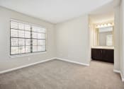 Thumbnail 12 of 33 - an empty bedroom with a large window and a bathroom