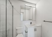 Thumbnail 8 of 46 - a bathroom with a sink toilet and a shower