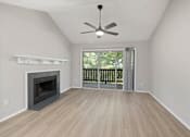 Thumbnail 32 of 67 - A room with a fireplace and sliding glass doors.