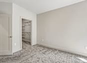 Thumbnail 41 of 64 - A room with a carpeted floor and a closet with a door open.