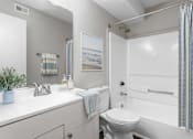 Thumbnail 5 of 46 - A bathroom with a white toilet and a white sink.