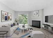 Thumbnail 2 of 46 - A living room with a fireplace and a television.