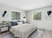 Thumbnail 4 of 46 - A bedroom with a large bed, a nightstand with a plant, and two framed artworks on the wall.