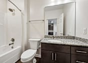 Thumbnail 29 of 51 - A white bathroom with a toilet, sink, and bathtub.