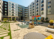 Thumbnail 7 of 36 - an open courtyard with an apartment building and a fountain