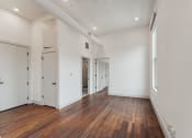 Thumbnail 4 of 46 - a living room with wood floors and white walls