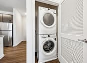 Thumbnail 31 of 51 - A white washer and dryer in a small laundry room.