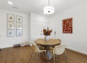 Thumbnail 17 of 51 - A dining room with a round table and chairs.