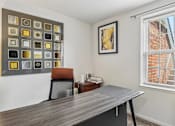 Thumbnail 50 of 54 - A room with a grey table and a brown chair.
