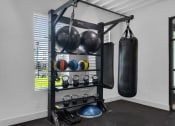 Thumbnail 19 of 35 - a home gym with a punching bag and weights at The Enclave at Deer Moss Creek, Niceville, Florida