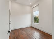 Thumbnail 10 of 46 - an empty room with wood floors and a window
