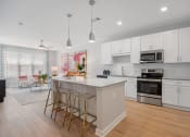 Thumbnail 3 of 29 - an open kitchen with an island with bar stools