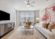 Thumbnail 4 of 29 - a living room with a couch and a tv