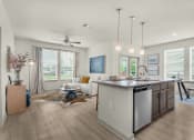 Thumbnail 2 of 35 - an open living room and kitchen with a ceiling fan at The Enclave at Deer Moss Creek, Florida