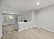 Thumbnail 35 of 67 - A spacious room with light grey walls and wooden flooring.