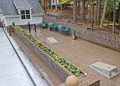 Thumbnail 61 of 67 - A patio with a hot tub and chairs.