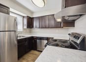 Thumbnail 3 of 33 - an updated kitchen with stainless steel appliances and marble counter tops