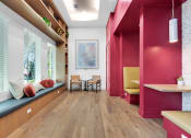 Thumbnail 24 of 35 - a living room with pink walls and a wood floor at The Enclave at Deer Moss Creek, Niceville, FL