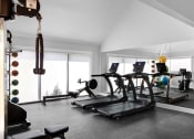 Thumbnail 4 of 33 - a gym with treadmills and other workout equipment in a home