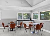 Thumbnail 26 of 33 - a dining room with a table and chairs