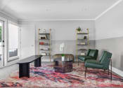 Thumbnail 25 of 33 - a living room with green chairs and a table